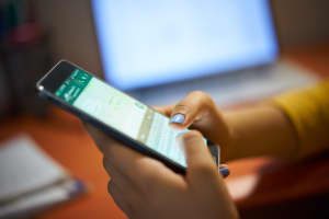 girl-typing-phone-message-on-social-network-at-PPVUP54